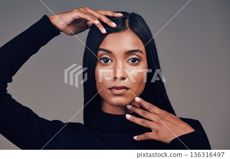 Face, beauty and skincare of confident woman in studio isolated on a gray background. Serious portrait, natural and Indian model with spa facial treatment for aesthetic, healthy skin and cosmetics. Face, beauty and skincare of confident woman in studio isolated on a gray background. Serious portrait, natural and Indian model with spa facial treatment for aesthetic, healthy skin and cosmetics. 136316497