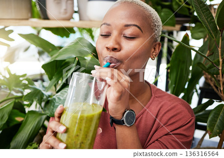 Health, diet and drink with black woman and smoothie for detox, breakfast and protein. Nutrition, food and weight loss with face of person and glass for green juice, vitamins and supplement Health, diet and drink with black woman and smoothie for detox, breakfast and protein. Nutrition, food and weight loss with face of person and glass for green juice, vitamins and supplement 136316564
