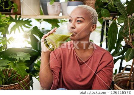 Healthy, black woman and drinking a green smoothie for nutrition with vegetables for supplement. Girl, detox and enjoying a vegan drink for home or weightloss with vitamin or plants and fruit shake. 136316578