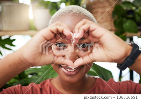 Black woman, portrait and face with heart hands for love, sign or shape in natural wellness or eco friendly store. Happy African female person with loving emoji, symbol or gesture for care in garden 136316651