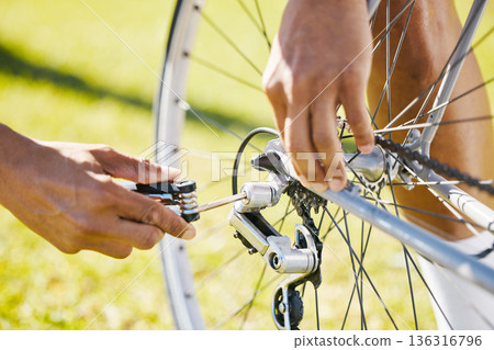 Bicycle, fixing and a man outdoor with wheel puncture or problem while cycling. Bike, hands and a sports person, cyclist or athlete check for maintenance, safety or repair with tools on flat tire Bicycle, fixing and a man outdoor with wheel puncture or problem while cycling. Bike, hands and a sports person, cyclist or athlete check for maintenance, safety or repair with tools on flat tire 136316796
