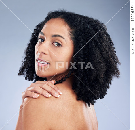Skin care, beauty and portrait of a woman with hand on shoulder for dermatology and cosmetics. Face of a young African female model on a studio background for self love, natural glow and soft touch 136316874