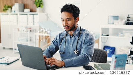 Man, doctor and reading with laptop in hospital for research, medical report and confirm surgery. Male person, pc and schedule appointment for Telehealth, healthcare results and treatment information 136316887
