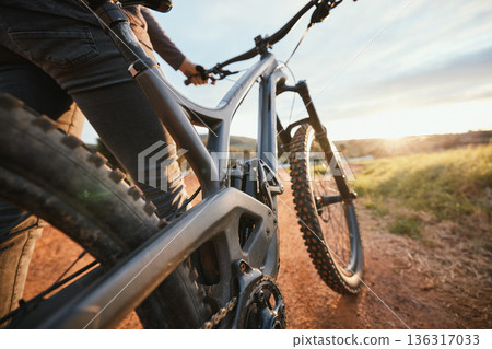 Sports, mountain bike and closeup of bicycle in nature for hobby, workout and exercise in countryside. Fitness, cyclist and person cycling for adventure, freedom and adrenaline on outdoor dirt road 136317033