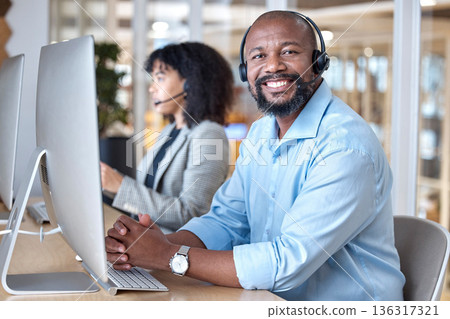 Call center, portrait of black man and smile at computer for customer service, business support and contact us in CRM office. Happy telemarketing agent at desktop for consulting in coworking agency Call center, portrait of black man and smile at computer for customer service, business support and contact us in CRM office. Happy telemarketing agent at desktop for consulting in coworking agency 136317321