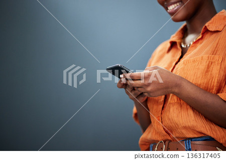 Typing, mockup and hands with a phone on a dark background for communication or social media. Smile, space and a black woman with a mobile for an app or chat isolated on a studio backdrop for web 136317405