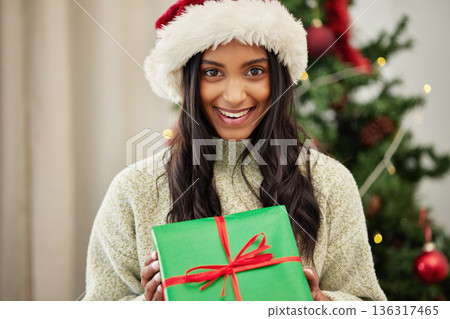 Christmas, portrait or happy woman with a gift box or present on a holiday celebration at home. Face, smile or excited Indian girl with special product or giveaway prize package in a house in winter Christmas, portrait or happy woman with a gift box or present on a holiday celebration at home. Face, smile or excited Indian girl with special product or giveaway prize package in a house in winter 136317465