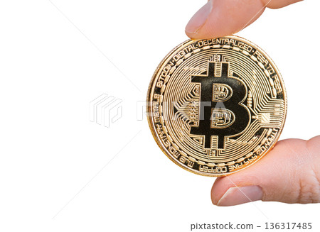 Bitcoin in female hand. Isolated on white background Bitcoin in female hand. Isolated on white background 136317485