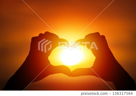 Herat shape made with hands on sunset sun light 136317564