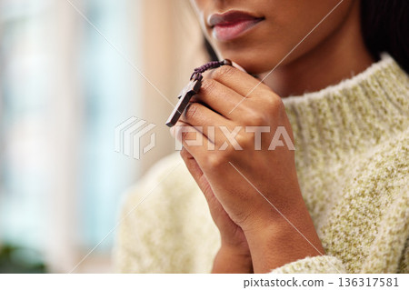 Rosary, hands and woman praying for help, faith or gratitude to God, praise and humble in her home. Jesus, worship and lady person in prayer with religious beads for hope, trust or Christian guidance 136317581