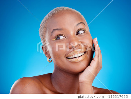 Makeup, studio face and happy black woman satisfied with glowing skin, aesthetic and facial cosmetics for skincare shine. Eyeliner, dermatology smile and thinking African person on blue background. 136317633