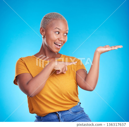 Decision, choice and black woman showing, presentation and information against a blue studio background. Discount deal, female person and excited model with options, advertising and product placement 136317637