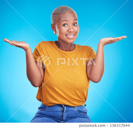 Black woman, shrug and confused portrait in studio with hand gesture, emoji or sign for doubt. African female model on a blue background for choice, decision or questions and why or unsure reaction Black woman, shrug and confused portrait in studio with hand gesture, emoji or sign for doubt. African female model on a blue background for choice, decision or questions and why or unsure reaction 136317644