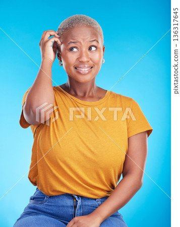 Black woman, scratch head and confused in studio with thinking, mindset or ideas for decision by blue background. African girl, stress and finger on hair for fear, scared and brainstorming for choice Black woman, scratch head and confused in studio with thinking, mindset or ideas for decision by blue background. African girl, stress and finger on hair for fear, scared and brainstorming for choice 136317645