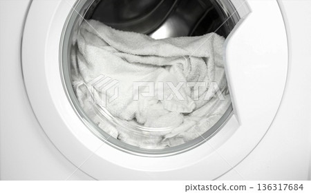 Process of cleaning white cloth in washing machine, closeup 136317684