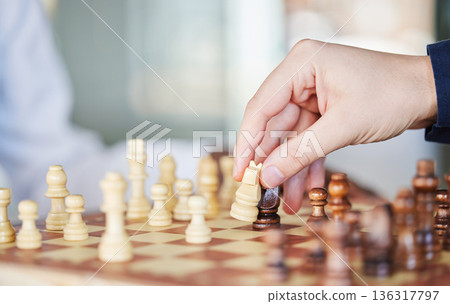 Playing, board game and chess checkmate with a man at a table while moving piece for strategy or challenge. Hands of a male person to play, relax and bond while moving icon for problem solving or win Playing, board game and chess checkmate with a man at a table while moving piece for strategy or challenge. Hands of a male person to play, relax and bond while moving icon for problem solving or win 136317797