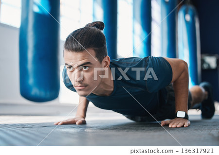 Fitness, push up or man in gym training or exercising in a workout for endurance or strong arms. Healthy person, focus or powerful sports athlete in exercise challenge for wellness or development 136317921