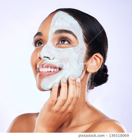 Smile, face mask and woman in studio with skincare, results and dermatology wellness on grey background. Facial, comparison and female with half beauty, routine and clay product for skin exfoliation Smile, face mask and woman in studio with skincare, results and dermatology wellness on grey background. Facial, comparison and female with half beauty, routine and clay product for skin exfoliation 136318069