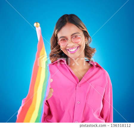 Woman, lgbtq and rainbow flag in studio portrait, sunglasses and icon for pride with human rights by blue background. Gen z girl, lesbian student and wave sign for solidarity, freedom and inclusion Woman, lgbtq and rainbow flag in studio portrait, sunglasses and icon for pride with human rights by blue background. Gen z girl, lesbian student and wave sign for solidarity, freedom and inclusion 136318112