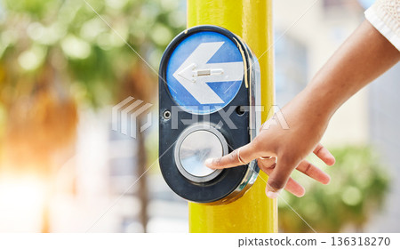 Crosswalk, arrow and button with hand of woman in city for traffic light, intersection and safety. Travel, sign and stop with person at pedestrian crossing in street for press, transport and warning 136318270