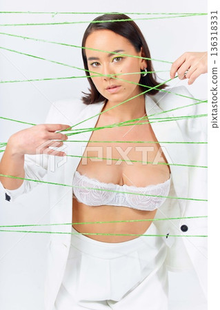 Makeup, art and strings with portrait of woman in studio for creative, fashion and cosmetics. Abstract, cotton and texture with face of model on white background for designer, trendy and textile Makeup, art and strings with portrait of woman in studio for creative, fashion and cosmetics. Abstract, cotton and texture with face of model on white background for designer, trendy and textile 136318331
