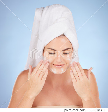 Shower, woman and washing face with foam in studio, blue background and cleaning cosmetics. Happy female model, facial skincare and soap for healthy aesthetic glow, dermatology or moisturizing beauty Shower, woman and washing face with foam in studio, blue background and cleaning cosmetics. Happy female model, facial skincare and soap for healthy aesthetic glow, dermatology or moisturizing beauty 136318333