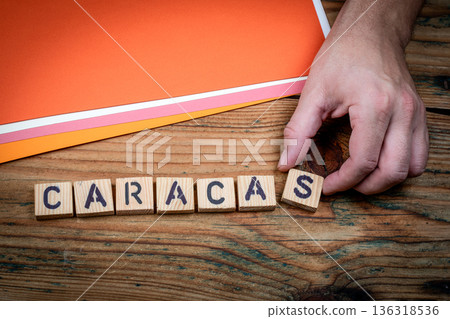 CARACAS Economic Crisis Concept Shown With Wooden Letter Blocks And Hand CARACAS Economic Crisis Concept Shown With Wooden Letter Blocks And Hand 136318536