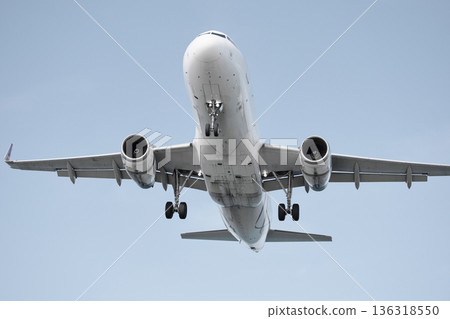 A huge passenger plane is landing in airport of Phuket, Thailand, a bottom view A huge passenger plane is landing in airport of Phuket, Thailand, a bottom view 136318550