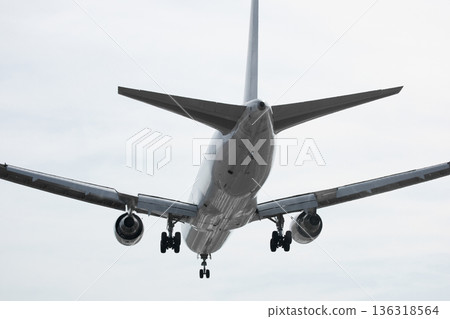 A huge passenger plane is landing in airport of Phuket, Thailand, a bottom view A huge passenger plane is landing in airport of Phuket, Thailand, a bottom view 136318564