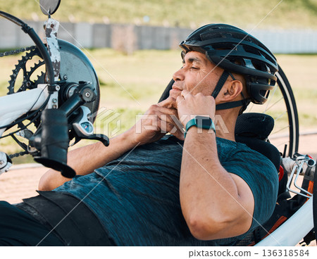 Helmet, athlete and a man with a disability and bike for handicap race, fitness and recumbent training. Exercise, protection and a handbike for paraplegic sports person outdoor for cycling or cardio 136318584