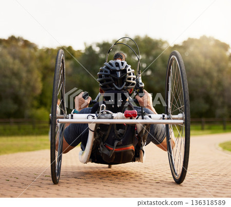 Disability, bicycle and paraplegic person cycling as morning exercise, workout or training for wellness and health. Handbike, sports and person on a wheelchair bike training strength and endurance Disability, bicycle and paraplegic person cycling as morning exercise, workout or training for wellness and health. Handbike, sports and person on a wheelchair bike training strength and endurance 136318589