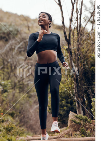 Nature, fitness running and woman for body training and cardio wellness, outdoor challenge or happy hiking. Sports runner, athlete or african person for health workout and marathon exercise in forest Nature, fitness running and woman for body training and cardio wellness, outdoor challenge or happy hiking. Sports runner, athlete or african person for health workout and marathon exercise in forest 136318690