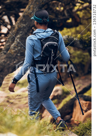 Hiking, travel and back of woman with stick for outdoor fitness, path and gear. Freedom, adventure or female hiker walking with trekking pole for exercise, health or balance in nature, trail and hill Hiking, travel and back of woman with stick for outdoor fitness, path and gear. Freedom, adventure or female hiker walking with trekking pole for exercise, health or balance in nature, trail and hill 136318732