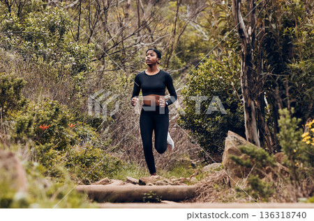 Forest, running and woman of fitness, body training and cardio wellness, outdoor challenge or hiking in nature. Runner, athlete or african sports person for workout goal or marathon exercise in woods Forest, running and woman of fitness, body training and cardio wellness, outdoor challenge or hiking in nature. Runner, athlete or african sports person for workout goal or marathon exercise in woods 136318740