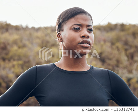 Fitness, black woman and workout in nature forest for health wellness. Training or exercise, motivation or breathing and serious female athlete in sportswear for marathon practice in woods thinking Fitness, black woman and workout in nature forest for health wellness. Training or exercise, motivation or breathing and serious female athlete in sportswear for marathon practice in woods thinking 136318741