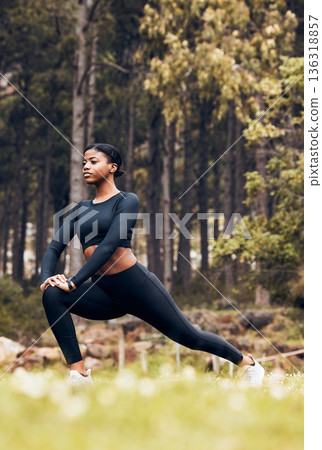 Stretching, fitness and black woman lunge in nature for exercise, training and sports in forest. Hiking, mountain and female person stretch legs for warm up, workout and wellness for performance 136318857