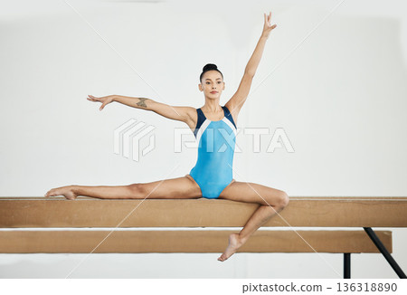 Gymnastics, sports and woman on beam in gym for rhythmic body movement, training and exercise. Aerobics performance, health and portrait of female dancer for competition, workout and dance practice Gymnastics, sports and woman on beam in gym for rhythmic body movement, training and exercise. Aerobics performance, health and portrait of female dancer for competition, workout and dance practice 136318890