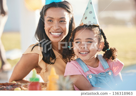 Party, outdoor and mother with girl, birthday and celebration with happiness, event and cheerful. Mama, daughter or female child with a happy parent, food and excited with hats, park or joy with love 136318963