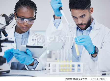 Man, black woman or scientists with test tubes in research for medical, experiment assessment or innovation. Tablet, studying biotechnology or researchers team in laboratory for science development Man, black woman or scientists with test tubes in research for medical, experiment assessment or innovation. Tablet, studying biotechnology or researchers team in laboratory for science development 136319018