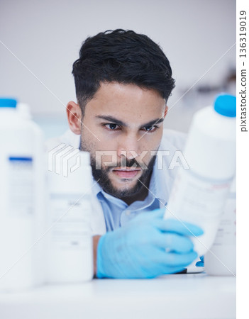Laboratory, man or scientist reading container to check medical stock or information on cure. Research study, bottle label data or science researcher in manufacturing job with chemical inventory 136319019