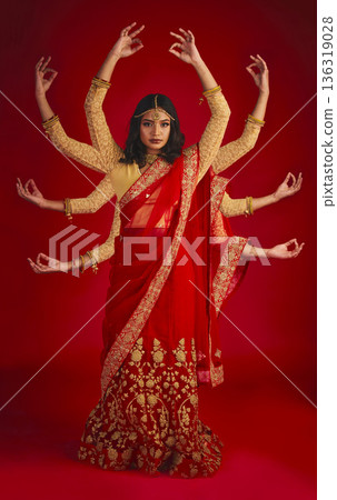 Indian woman, studio and culture with mudra, portrait and magic for culture, yoga and fashion by red background. Girl, model and beauty for fantasy, jewellery and art with clothes for festive event Indian woman, studio and culture with mudra, portrait and magic for culture, yoga and fashion by red background. Girl, model and beauty for fantasy, jewellery and art with clothes for festive event 136319028