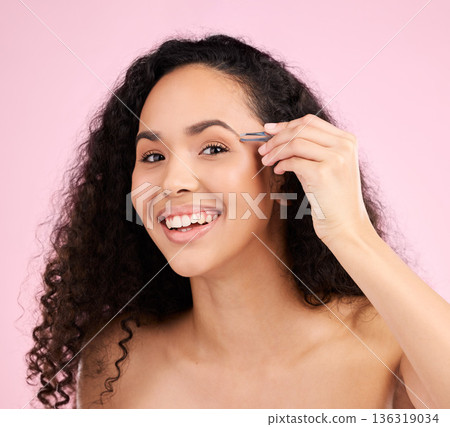 Face, smile and woman with tweezer for eyebrow beauty in studio isolated on a pink background. Natural portrait, facial plucking or hair removal of model for self care, cosmetic wellness or aesthetic 136319034