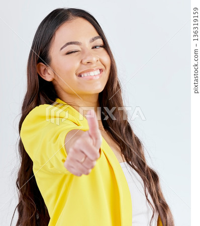 Portrait, support and woman with thumbs up, promotion and success against a white studio background. Wink, female person or model with hand gesture, achievement or like with symbol or positive review Portrait, support and woman with thumbs up, promotion and success against a white studio background. Wink, female person or model with hand gesture, achievement or like with symbol or positive review 136319159