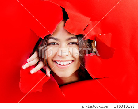 Portrait, breaking wall and woman with a smile, new and breakthrough with happiness, excited or promotion. Face, female person or model with a hole, boundary or torn with experience, peek or surprise 136319185