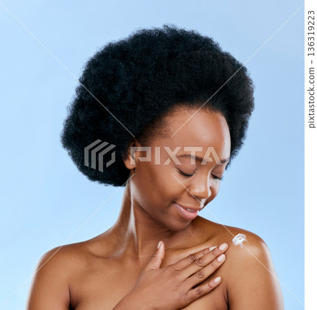 Black woman, cream and beauty, body care and cosmetics with moisturizer isolated on blue background. Dermatology, African model and sunscreen with skincare, afro hair and wellness with grooming 136319223