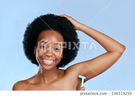 Smile, portrait or black woman woman shaving armpit with a razor blade for hair removal, hygiene or wellness. Studio, blue background or happy girl model grooming underarms for healthy clean skincare Smile, portrait or black woman woman shaving armpit with a razor blade for hair removal, hygiene or wellness. Studio, blue background or happy girl model grooming underarms for healthy clean skincare 136319250