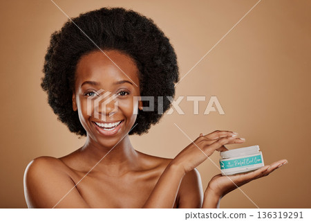 Portrait, hair and keratin product with a black woman in studio on a brown background for cosmetics. Face, smile and haircare treatment in the palm of a happy female model for natural afro hairstyle 136319291