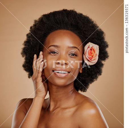 Black woman, face and skincare with rose in studio isolated on a brown background. Portrait, flower and happy African model with natural cosmetics, organic facial treatment and floral beauty plant. Black woman, face and skincare with rose in studio isolated on a brown background. Portrait, flower and happy African model with natural cosmetics, organic facial treatment and floral beauty plant. 136319371