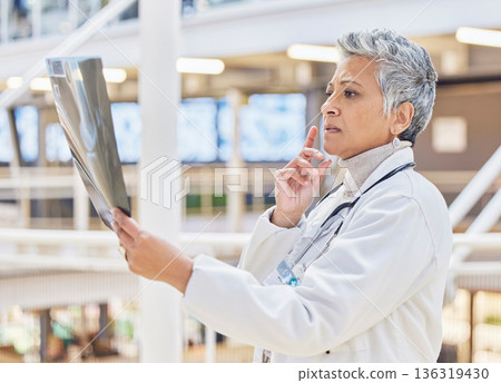 Xray, doctor or mature woman thinking of solution in hospital for healthcare research, results or analysis. MRI, exam check or senior medical worker planning for anatomy review or injury assessment Xray, doctor or mature woman thinking of solution in hospital for healthcare research, results or analysis. MRI, exam check or senior medical worker planning for anatomy review or injury assessment 136319430