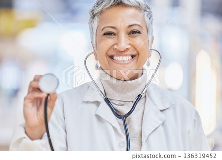 Portrait, medical and stethoscope with an old woman doctor in the hospital for cardiology or treatment. Healthcare, heart health and wellness with a senior female medicine professional in a clinic Portrait, medical and stethoscope with an old woman doctor in the hospital for cardiology or treatment. Healthcare, heart health and wellness with a senior female medicine professional in a clinic 136319452